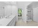 Bright bathroom with double sinks, large mirrors, and walk-in shower with glass door at 2602 Vintage Hill Ct, Durham, NC 27712