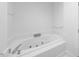 Corner bathtub with jacuzzi jets in bright, white bathroom at 2602 Vintage Hill Ct, Durham, NC 27712