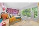 Bright, stylish bedroom with playful wallpaper, large window, and unique decor at 2602 Vintage Hill Ct, Durham, NC 27712