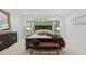 Cozy bedroom features large windows, wood furniture, and an inviting, neutral color palette at 2602 Vintage Hill Ct, Durham, NC 27712