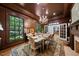 Elegant dining room with a fireplace, chandelier, and large window overlooking the lush landscaping at 2602 Vintage Hill Ct, Durham, NC 27712
