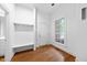 Entryway featuring hardwood floors, a built-in bench, and natural light from a large window at 2602 Vintage Hill Ct, Durham, NC 27712