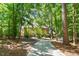 Beautiful home exterior with manicured lawn, mature trees, and a circular driveway at 2602 Vintage Hill Ct, Durham, NC 27712