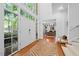 Bright foyer with hardwood floors, a double-door entrance, and views into the home office at 2602 Vintage Hill Ct, Durham, NC 27712