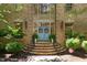 Inviting front entrance featuring brick steps, a blue double-door entrance, and well-manicured landscaping at 2602 Vintage Hill Ct, Durham, NC 27712