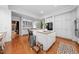 Bright kitchen with white cabinets, hardwood floors, kitchen island, and stainless appliances at 2602 Vintage Hill Ct, Durham, NC 27712