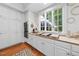 Updated kitchen with white cabinets, hardwood floors, and built-in stainless steel oven at 2602 Vintage Hill Ct, Durham, NC 27712