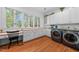 Bright laundry room features built-in desk, ample cabinet space, and modern appliances at 2602 Vintage Hill Ct, Durham, NC 27712