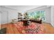Cozy living room featuring hardwood floors, large windows, and comfortable seating arrangements at 2602 Vintage Hill Ct, Durham, NC 27712