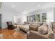 Cozy living room featuring hardwood floors, a fireplace, and lots of comfortable seating at 2602 Vintage Hill Ct, Durham, NC 27712