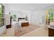Bright main bedroom with multiple windows, neutral carpet, and classic furnishings at 2602 Vintage Hill Ct, Durham, NC 27712