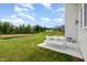 Backyard with a pond view, patio area, and furniture on a sunny day at 27 Silver Moon Ln, Clayton, NC 27527
