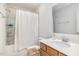 Bright bathroom with a shower-tub combination, framed mirror, and light wood vanity at 27 Silver Moon Ln, Clayton, NC 27527