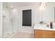 Modern bathroom featuring a glass walk-in shower, hexagon tile flooring, and a wood vanity at 27 Silver Moon Ln, Clayton, NC 27527