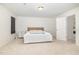 Minimalist bedroom with neutral tones, carpeted floors, and a comfortable bed, creating a serene space at 27 Silver Moon Ln, Clayton, NC 27527