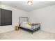 Cozy bedroom with a dark metal bed frame, soft bedding, and carpet at 27 Silver Moon Ln, Clayton, NC 27527