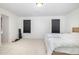 Bright bedroom with minimal decor, carpeted floors, and natural light streaming through the windows at 27 Silver Moon Ln, Clayton, NC 27527