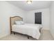 Cozy bedroom with a simple bed frame, neutral carpet, and a single window for natural light at 27 Silver Moon Ln, Clayton, NC 27527