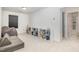 Cozy bonus room with comfortable seating, built-in bookshelves, and carpeted floors, perfect for relaxation at 27 Silver Moon Ln, Clayton, NC 27527