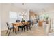 Open-concept dining room with a rustic wooden table and an adjacent kitchen at 27 Silver Moon Ln, Clayton, NC 27527