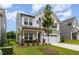 Charming two-story home with stone accents, a well-manicured lawn, and a two-car garage at 27 Silver Moon Ln, Clayton, NC 27527
