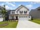 Charming two-story home with stone accents, a well-manicured lawn, and a two-car garage at 27 Silver Moon Ln, Clayton, NC 27527