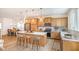 Bright eat-in kitchen with stainless appliances, island with seating, light wood cabinets, and modern lighting fixtures at 27 Silver Moon Ln, Clayton, NC 27527