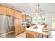 Spacious kitchen featuring stainless steel appliances, a white marble island, and custom cabinets at 27 Silver Moon Ln, Clayton, NC 27527