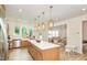 Spacious kitchen featuring stainless steel appliances, a white marble island, and barstool seating at 27 Silver Moon Ln, Clayton, NC 27527