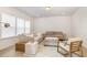 Comfortable living room featuring neutral decor, a cozy seating arrangement, and plenty of natural light from large windows at 27 Silver Moon Ln, Clayton, NC 27527