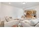 Open-concept living room featuring a neutral palette, comfortable furnishings, and seamless flow into the kitchen at 27 Silver Moon Ln, Clayton, NC 27527