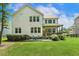 Beautiful backyard view of the home with a patio, screened-in porch, and lush green lawn at 2716 Willow Rock Ln, Apex, NC 27523