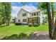 Spacious backyard with lush green grass, a well-manicured lawn, and an inviting screened-in porch at 2716 Willow Rock Ln, Apex, NC 27523