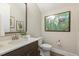 Bathroom featuring an elegant marble countertop, a modern sink, and decorative wall art, creating a serene ambiance at 2716 Willow Rock Ln, Apex, NC 27523