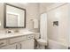 Modern bathroom featuring a vanity with sink, toilet, and shower with stylish white subway tiles at 2716 Willow Rock Ln, Apex, NC 27523