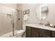 Bathroom features a glass enclosed shower, dark vanity, and a large oval mirror at 2716 Willow Rock Ln, Apex, NC 27523