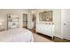 Bedroom showing decor, view into bathroom, and white dresser for a stylish and functional space at 2716 Willow Rock Ln, Apex, NC 27523