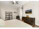 Bright bedroom features a ceiling fan, dark wood floors, and decorative artwork at 2716 Willow Rock Ln, Apex, NC 27523