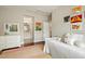 Bedroom featuring colorful art, a single bed, and an adjoining bathroom for a vibrant and comfortable space at 2716 Willow Rock Ln, Apex, NC 27523