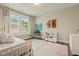 Well-lit bedroom features a desk, decor and a comfortable bed, creating a cozy and inviting atmosphere at 2716 Willow Rock Ln, Apex, NC 27523