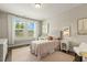 Cozy bedroom featuring a twin bed, large windows, desk, and chair creating a bright and welcoming space at 2716 Willow Rock Ln, Apex, NC 27523