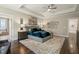 Spacious bedroom showcasing plush carpet, stylish decor, tray ceiling, and a luxurious bed with soft, inviting bedding at 2716 Willow Rock Ln, Apex, NC 27523