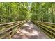 Take a stroll on a wooden walking bridge, with a tranquil escape into a natural, tree-lined environment at 2716 Willow Rock Ln, Apex, NC 27523