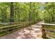 Greenway's wooden bridge is surrounded by trees, with trails to Green Level Church Road at 2716 Willow Rock Ln, Apex, NC 27523