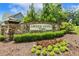 Stone sign welcomes you to Green Level Estates, surrounded by lush landscaping and established trees at 2716 Willow Rock Ln, Apex, NC 27523