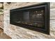 Contemporary Heat & Glo fireplace with decorative stone surround, enhancing the room's modern aesthetic at 2716 Willow Rock Ln, Apex, NC 27523