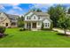 Beautiful two-story home with a lush green lawn and a well-manicured landscape at 2716 Willow Rock Ln, Apex, NC 27523