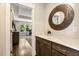 Hallway with a white quartz topped cabinet and view to living room at 2716 Willow Rock Ln, Apex, NC 27523