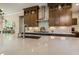 A bright kitchen with white countertops, stainless steel faucet, dark wood cabinets, and white subway tile backsplash at 2716 Willow Rock Ln, Apex, NC 27523