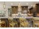 An island kitchen featuring counter seating, stainless steel appliances, tile backsplash, and modern cabinets at 2716 Willow Rock Ln, Apex, NC 27523